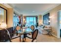 Comfortable living room with a dining table, comfortable seating, built in cabinets and large windows at 145 E Harmon Ave # 1202, Las Vegas, NV 89109