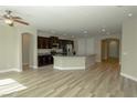 Bright, open kitchen with stainless steel appliances, granite countertops, dark cabinets, and wood flooring at 1617 Meadow Bluffs Ave, Henderson, NV 89014
