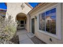 Close-up of the arched entrance showcasing a front door with decorative side lights at 1687 Wellington Springs Ave, Henderson, NV 89052