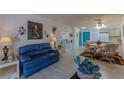Open-concept living room with dining area, blue accent door and tile flooring at 205 E Harmon Ave # 121, Las Vegas, NV 89169