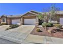 Street view of the townhome showcases its front yard, garage, and overall curb appeal at 211 Crown Imperial St, Henderson, NV 89074