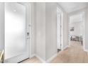 Bright hallway with light wood floors, white trim, and access to other rooms at 2503 Cracked Stone St, Henderson, NV 89044