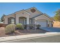 Well-manicured lawn and mature landscaping accent the front of this charming single story home at 2617 Tanagrine Dr, North Las Vegas, NV 89084
