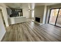 Spacious living room with fireplace, wood flooring, and a sliding door at 2964 Juniper Hills Blvd # 202, Las Vegas, NV 89142
