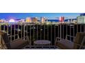 Balcony view showcasing the Las Vegas skyline at night with outdoor seating at 3111 Bel Air Dr # 12C, Las Vegas, NV 89109