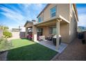 Inviting backyard featuring artificial grass and a covered patio, ideal for outdoor entertaining and relaxation at 3746 Bright Aquarius Ln, Henderson, NV 89052