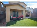 Cozy backyard patio with a covered area, complete with stylish outdoor furniture and a lush lawn at 3746 Bright Aquarius Ln, Henderson, NV 89052
