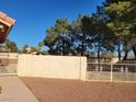 Fenced backyard with desert landscaping and mature shade trees at 4135 Al Carrison St, Las Vegas, NV 89129