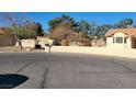 Well-maintained front yard with mature trees and desert landscaping at 4135 Al Carrison St, Las Vegas, NV 89129