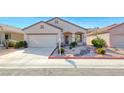 Well-maintained single-story home with desert landscaping, two-car garage, and sidewalk access at 473 Elm Crest Pl, Henderson, NV 89012