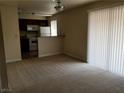 Bright living room with neutral carpet, and natural light from a large window at 4965 Indian River Dr # 108, Las Vegas, NV 89103