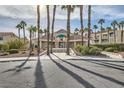 Laguna Del Rey Community Clubhouse entrance flanked by mature palm trees and lush garden landscaping at 5000 Red Rock St # 105, Las Vegas, NV 89118