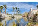 Scenic view of Laguna Del Rey community pond with fountain, palm trees and lush landscape at 5000 Red Rock St # 105, Las Vegas, NV 89118
