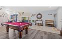 Spacious living area showcasing pool table and elegant decor with tile and wood flooring at 5009 Rustic Charm Ct, Las Vegas, NV 89131