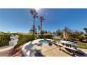 Inviting backyard oasis with a sunken spa, lush landscaping, and outdoor seating area at 5449 Bugle Way # 102, Las Vegas, NV 89108