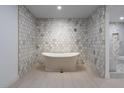 Beautiful soaking tub situated in a luxurious bathroom with unique tile design and sleek fixtures at 714 Lacy Ln, Las Vegas, NV 89107