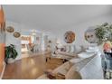 Bright living room featuring wood floors, white walls, and an open floor plan at 7274 Pinebrook Cir, Las Vegas, NV 89147