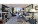 Cozy living room showcasing a modern fireplace, gray rug, stylish seating, and bright balcony view at 730 S Royal Crest Cir # 424, Las Vegas, NV 89169