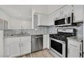 Modern kitchen featuring stainless steel appliances, granite countertops, and attractive backsplash at 9050 W Warm Springs Rd # 2153, Las Vegas, NV 89148