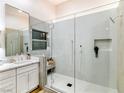 This bathroom boasts a glass shower, sleek white tile, and a stylish vanity with a marble countertop at 9741 Panorama Cliff Dr, Las Vegas, NV 89134