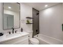 Bathroom features modern fixtures, a soaking tub, an accent wall, and a vanity with white marble countertop at 9741 Panorama Cliff Dr, Las Vegas, NV 89134