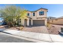 Beautiful home exterior features lush landscaping and a brick-paved driveway at 981 Soaring Moon Dr, Henderson, NV 89015