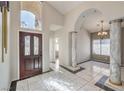 Elegant foyer with tile flooring, high ceilings, decorative columns, and stylish lighting at 105 Eagleview Ct, Henderson, NV 89074