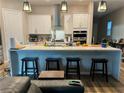 Modern kitchen featuring a large center island with seating, stainless steel appliances, and ample counter space at 12451 Island Bells Ave, Las Vegas, NV 89138