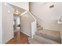 The foyer features hardwood floors, a neutral palette, and a carpeted staircase leading to the upper level at 1804 Michael Ct, Henderson, NV 89014