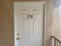 A clean, white front door with the unit number '230' displayed prominently at 1830 N Pecos Rd # 230, Las Vegas, NV 89115