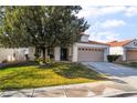Inviting single-story home featuring a lush green lawn and a spacious two-car garage at 1835 Swallow Hill Ave, Henderson, NV 89012