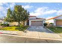 Well-maintained single-story home with a tile roof, green lawn, and mature landscaping at 1835 Swallow Hill Ave, Henderson, NV 89012