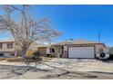 Attractive single-story home with a large driveway and an attached two-car garage at 216 Candlelight St, Las Vegas, NV 89145