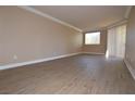 Spacious living room featuring wood-look floors, neutral walls, and natural light at 220 E Flamingo Rd # 116, Las Vegas, NV 89169