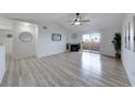 Bright open living room with wood-look floors, fireplace, ceiling fan, and access to patio at 231 W Horizon Ridge Pkwy # 1027, Henderson, NV 89012