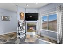 Cozy living room featuring a fireplace, large window, and view of the neighborhood at 262 Big Horn Dr, Boulder City, NV 89005