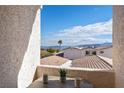 Balcony view overlooking neighboring rooftops with blue sky, lake and mountain background at 262 Big Horn Dr, Boulder City, NV 89005