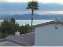 A stunning view with a palm tree in front of a lake and mountains at 262 Big Horn Dr, Boulder City, NV 89005