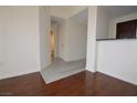 Hallway with hardwood floors leading to the kitchen and bathroom with bright white walls at 270 E Flamingo Rd # 327, Las Vegas, NV 89169