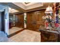 Elegant hallway with double wood doors, wall mirrors, stone floors and classic decor at 2747 Paradise Rd # 801, Las Vegas, NV 89109
