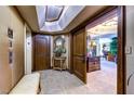 Elegant hallway featuring beautiful wood doors, stone floors, seating and elegant decor at 2747 Paradise Rd # 801, Las Vegas, NV 89109