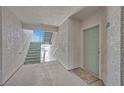 Exterior hallway leads to unit door, featuring stairs and a view of the surrounding area at 3550 Bay Sands Dr # 2087, Laughlin, NV 89029