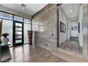 Grand entryway featuring a decorative statue, wood flooring, and abundant natural light at 431 Tranquil Peak Ct, Henderson, NV 89012