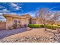 Front yard features desert landscaping, a healthy tree and well maintained bushes at 5071 Andover Ct, Pahrump, NV 89061