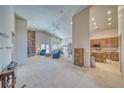 Spacious living room with a stone fireplace, vaulted ceilings, and large windows at 5071 Andover Ct, Pahrump, NV 89061