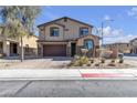 Charming two-story home featuring a brick driveway, two-car garage, and desert landscaping at 5820 Delaney Falls St, North Las Vegas, NV 89081