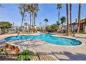 Resort-style pool with sun loungers and lush landscaping at 600 Willow Green Dr, Las Vegas, NV 89169