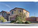 View of a well-kept house with a good-sized yard, situated on a neatly paved road, underneath a partly cloudy blue sky at 6307 Point Isabel Way, Las Vegas, NV 89122