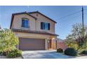 Charming two-story home featuring a covered porch and attached garage, showcasing a well-maintained lawn and inviting curb appeal at 6307 Point Isabel Way, Las Vegas, NV 89122