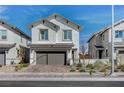 Charming two-story home featuring a well-manicured front yard and a two-car garage at 690 Monroe Hill Pl, Henderson, NV 89011